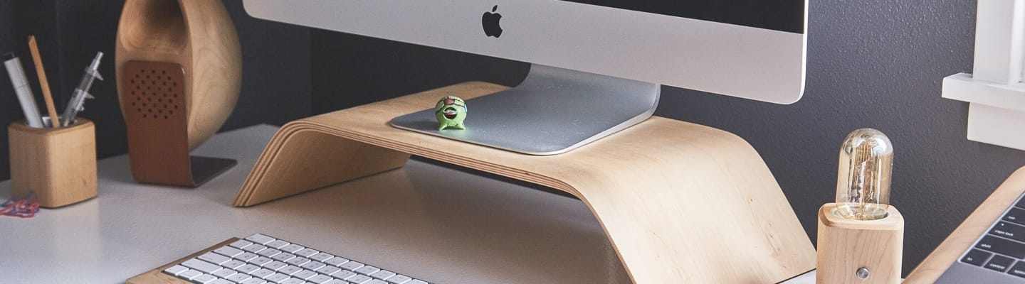 Apple monitor placed over moniter riser.