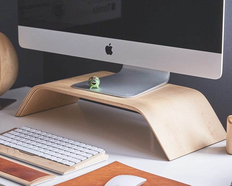 Apple monitor placed over moniter riser.